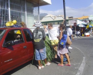 Tourists buying coconuts from a vendor in Dominica 