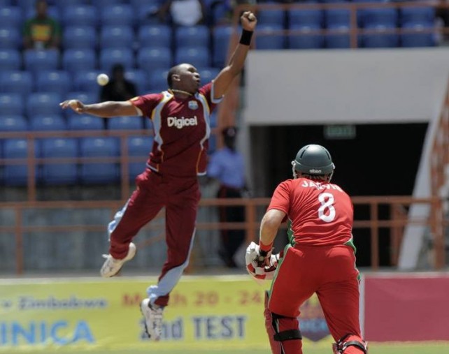 Dwayne Bravo jumps to make a save from a powerful shot by Kyle Jarvis during the 3rd ODI West Indies v Zimbabwe at Grenada National Stadium, St George's, Grenada. WICB Media/Randy Brooks Photo