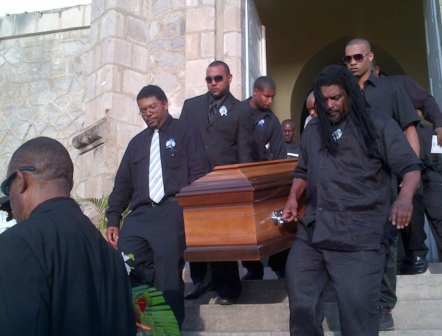 The coffin being taken out of church