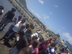 Onlookers at the scene where the body of the woman was brought ashore