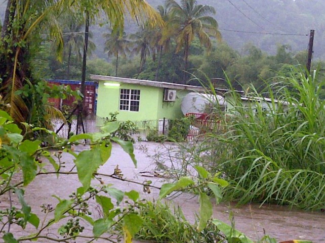 A house surrounded by flood waters in Castle Bruce