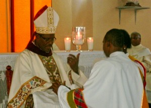 John's hands are anointed by Bishop Malzaire