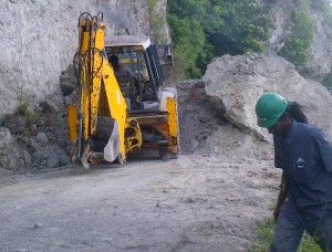 Eart moving equipment clearing landslide at Pointe. Michel
