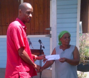 The parent of a student from Layou receives a check from MP Kelver Darroux