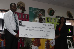 Minister of Culture Justina Charles accepts a cheque on behalf of National Cultural Council