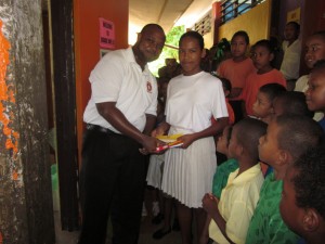 A rep from United Insurance presenting the items to a student