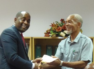PM Skerrit presents the cheque to DAPEX's chairman Luke Prevost