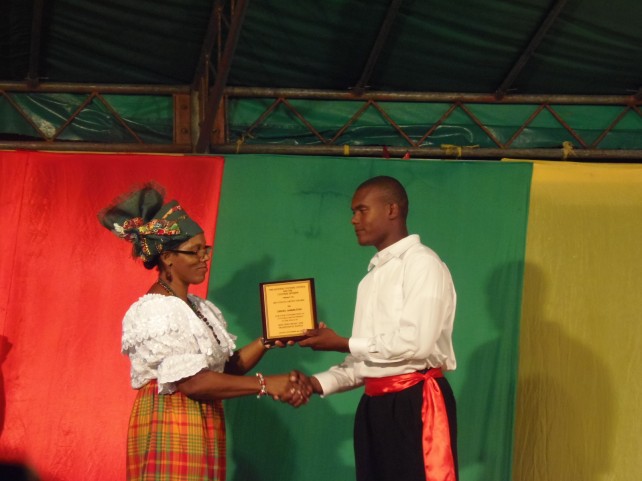 Audel Hamilton receives his award from culture minister Justina Charles