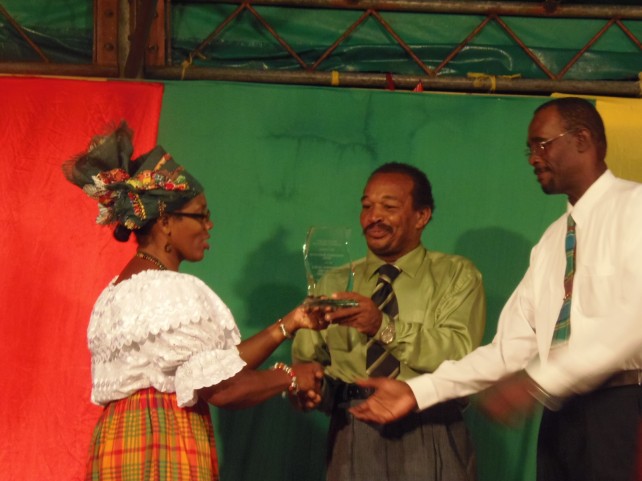 Representatives of the local government vehicle staff accepts the award from culture minister Justina Charles 
