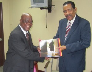 Bonti Liverpool receives his copy of the book from President Charles Savarin