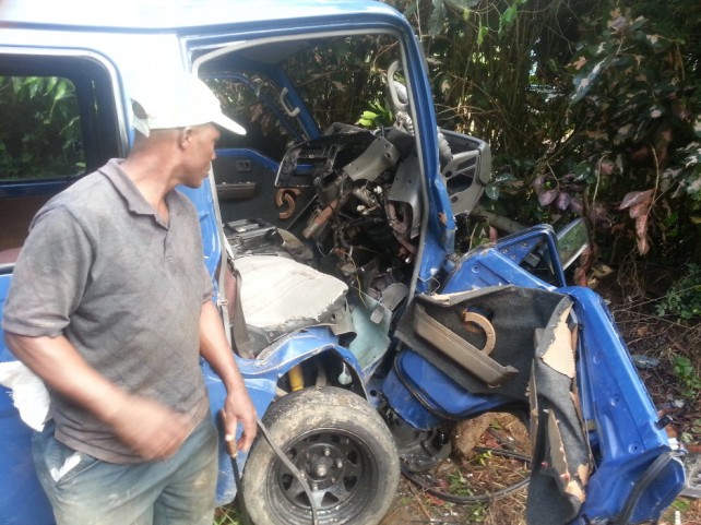 A man looks at one of the vehicles involved in the accident