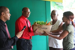 Minister presents food basket to Grotto Home