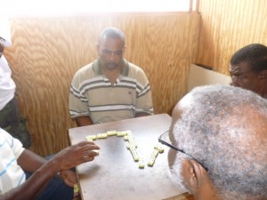 Domino players pondering their next move during a domino game