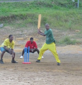 Villagers playing cricket at a playing field in Grand Fond