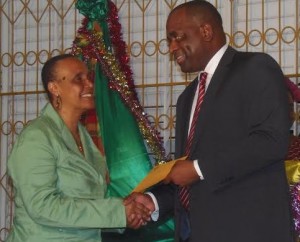 PM Skerrit hands over the cheque to DAPD's Nathalie Murphy