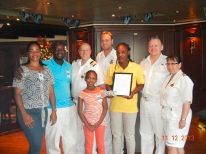 Steline Joseph poses with her award with family and crew members 
