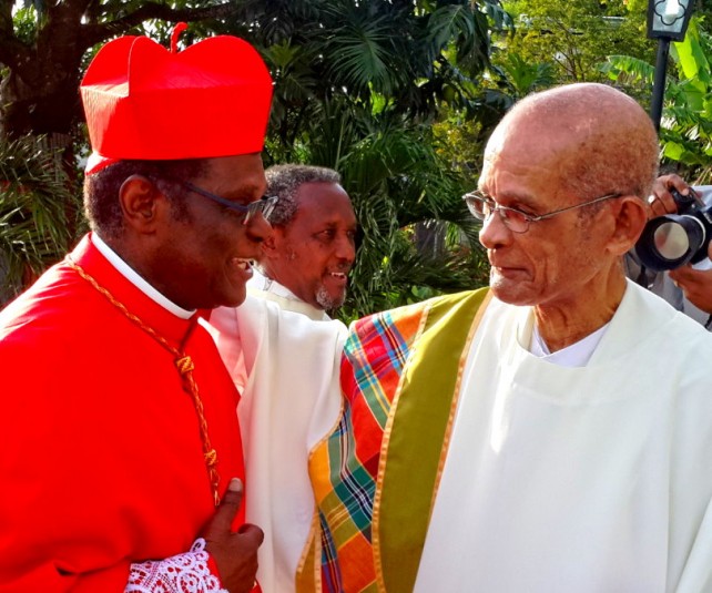 Cardinal Felix (left) shares a word with another prominent Catholic priest from Dominica,  Fr. Clement Jolly 