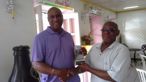 Layne presents a copy of his book to a Dominican