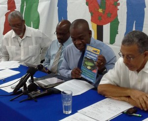 Linton displays a copy of the UWP 2000 manifesto at a press conference