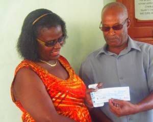 MP George presents the check to a member of the reunion committee