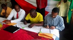 PM Skerrit looks on as a contract is signed for road works in Grand Fond. Photo by Press Attache of the PM