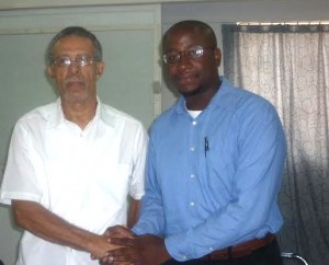 Auguiste (right) shakes hands with former education minister, Ron Green 