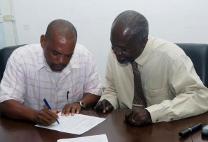 Clement Royer (left) signs the contract for the Titou Gorge project