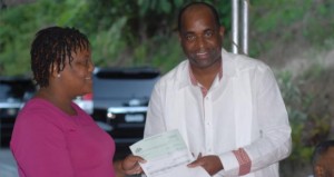Prime Minister Skerrit hands over cheque to Village Council Chairman Kerry St. Hillaire