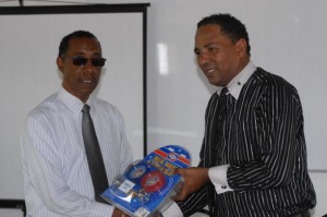 Dr. Darroux (right) makes the presentation to Dr. Peters
