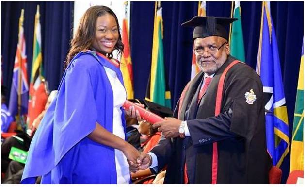 Sabra Luke smilingly accepts her diploma