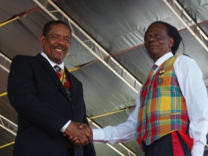 James shakes hands with president Charles Savarin after receiving his award