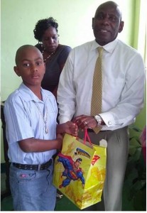Pastor Colymore with one of the recipients