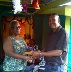 Billy Doctrove of Big Edge hands over the donation to Lucia Blaize of the Grotto Home 