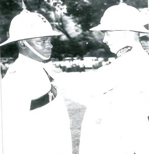 The First Dominica Born Police Chief –Damase Philbert being awarded the Colonial Service Medal by British Administrator of Dominica Col Alec Lovelace upon his elevation to Chief in 1964