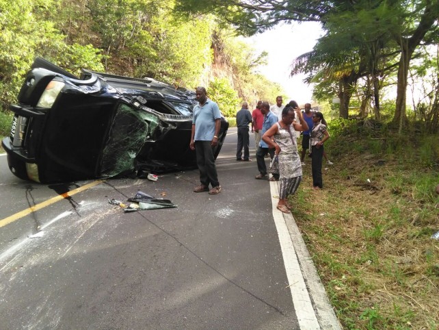 The extensively damaged vehicle lying on its side in the road at Batalie