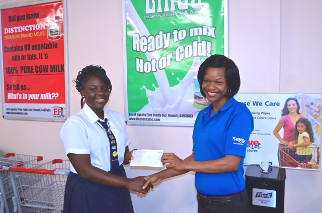 Janae receives a cheque from Save a Lot employee