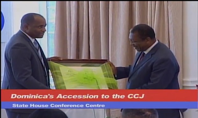 PM Skerrit makes a presentation to CCJ President Sir Dennis Byron at Friday's ceremony 