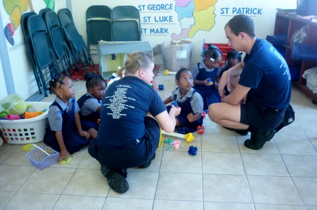 Crew members interact with student of the Charlotte's Preschool 