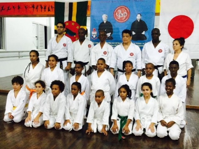 Students pose with instructors after receiving belts 