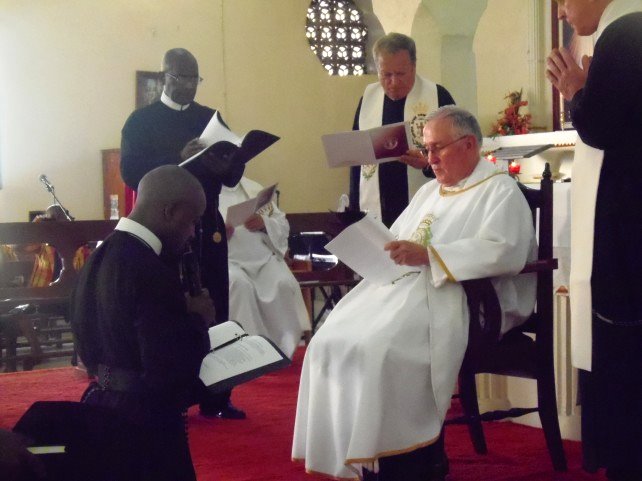 Auguiste (kneeling) took his final religious vows last year