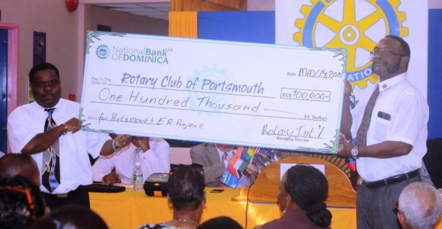A ceremonial check for the project is presented to the Club's president, Morrison Azille (left) by Haynes Jacob of Rotary International 