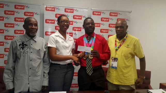Natalie Walsh of Digicel presents a check to special Olympian Claudius Shipley, while Shipley's adopted father, Josephat Williams (left) and Ainsworth Irish look on   