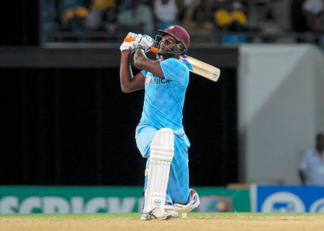 Allrounder Carlos Brathwaite plays a switch hit for six into the Greenidge & Haynes Stand