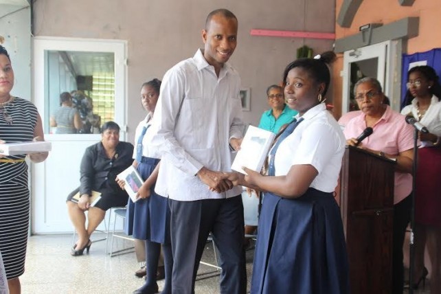 A student from St. Martin Primary receives her tablet 