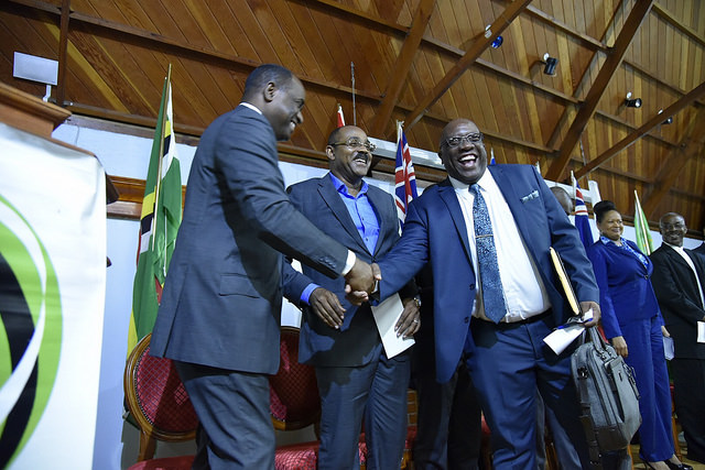 Dr. Harris shakes hands with PM Skerrit at OECS Authority meeting