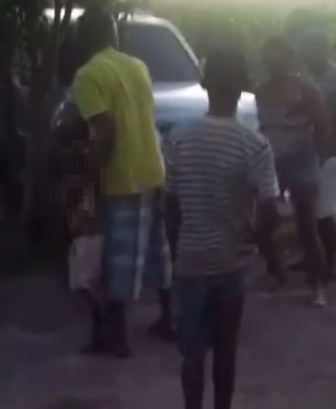 A shot from the video shows a man attempting to rescue the child from the fracas 