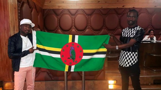 Devine and his promoter display a Dominica flag in Jamaica 