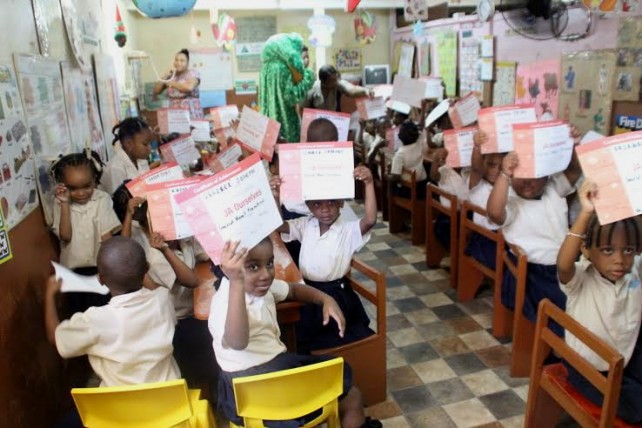 Students show certificates for participating in the program