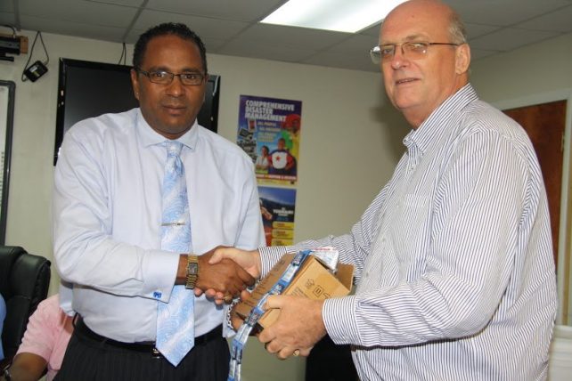 Dr. Darroux receives donation from ChildFund's Paul Bode