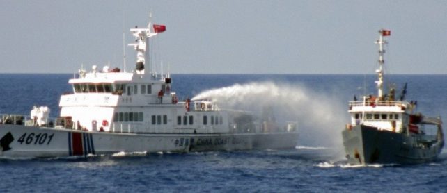 A Chinese coastguard vessel (L) uses water cannon on a Vietnamese Sea Guard ship on the South China Sea near the Paracels islands, in this handout photo taken on May 4, 2014 and released by Vietnam Marine Guard on May 8, 2014